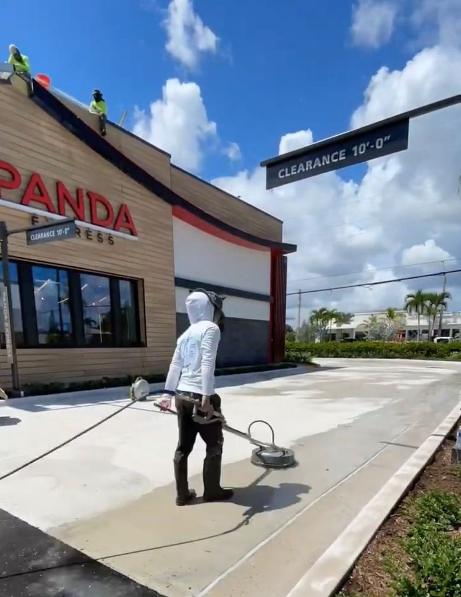 Applying Pressure technician detailing the exterior of a Panda Express location in South Florida
